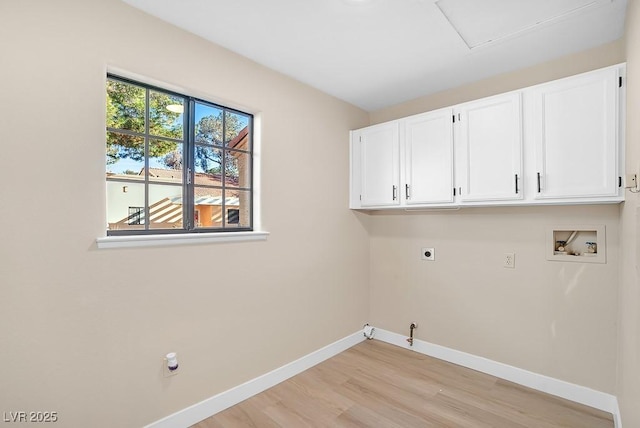 clothes washing area featuring cabinet space, baseboards, hookup for a gas dryer, hookup for a washing machine, and hookup for an electric dryer