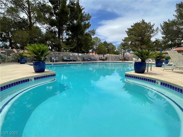 pool featuring a patio area and fence