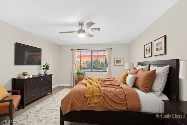 bedroom featuring baseboards, visible vents, and a ceiling fan