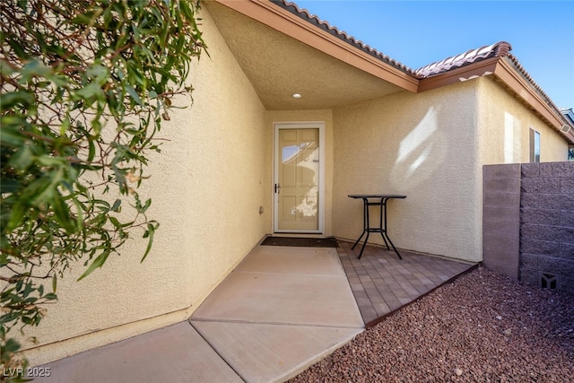 entrance to property with a patio area