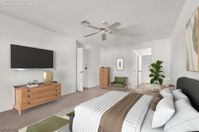 carpeted bedroom featuring ceiling fan and a textured ceiling