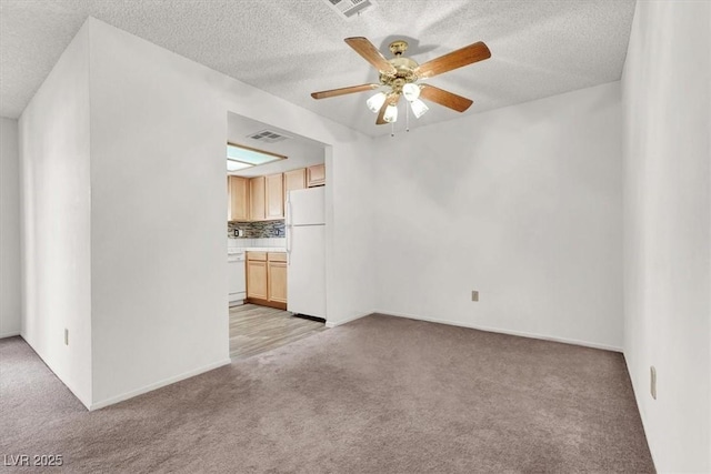 unfurnished living room featuring a textured ceiling, light colored carpet, and ceiling fan