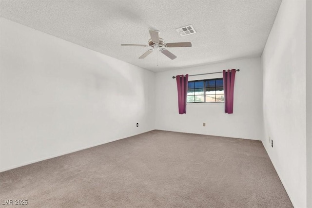 carpeted empty room with a textured ceiling and ceiling fan