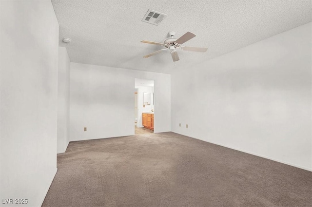 unfurnished room with ceiling fan, light colored carpet, and a textured ceiling