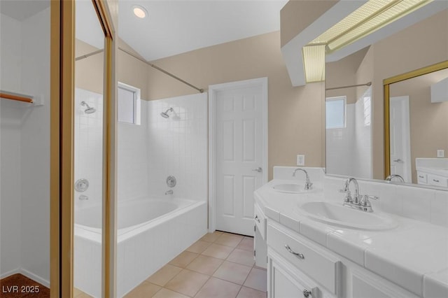 bathroom featuring tile patterned flooring, vanity, and tiled shower / bath