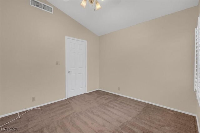 unfurnished room with vaulted ceiling, ceiling fan, and carpet flooring