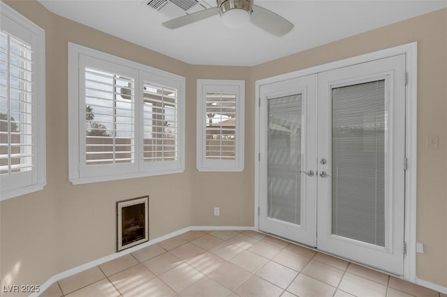 spare room with light tile patterned floors, ceiling fan, and french doors