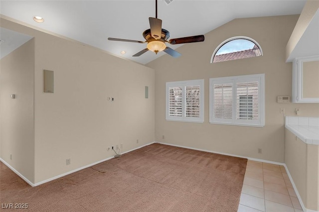 unfurnished living room featuring ceiling fan, high vaulted ceiling, and light tile patterned floors