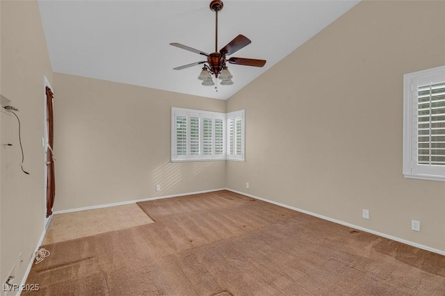 carpeted empty room featuring vaulted ceiling and ceiling fan