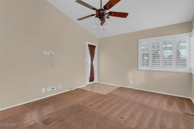 carpeted spare room featuring high vaulted ceiling and ceiling fan