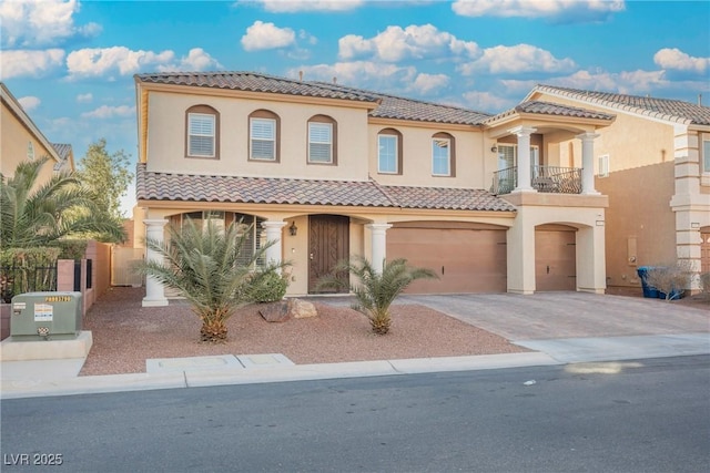 mediterranean / spanish-style house featuring a garage and a balcony