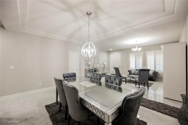 dining area featuring an inviting chandelier and a tray ceiling