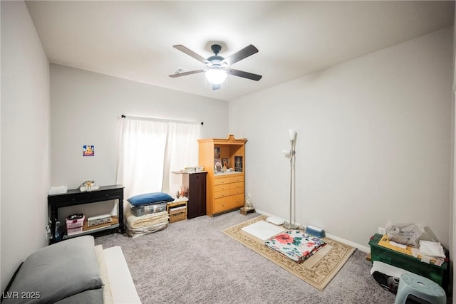 interior space with ceiling fan and carpet