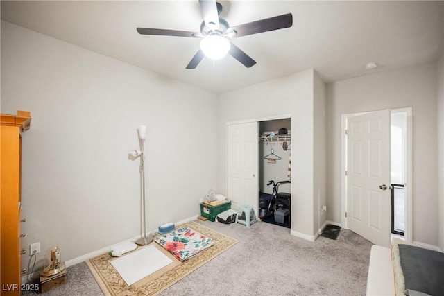 interior space featuring light carpet and ceiling fan