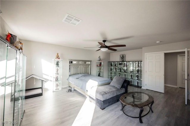 bedroom with hardwood / wood-style floors and ceiling fan