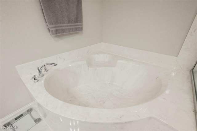 bathroom featuring tile patterned flooring and a tub