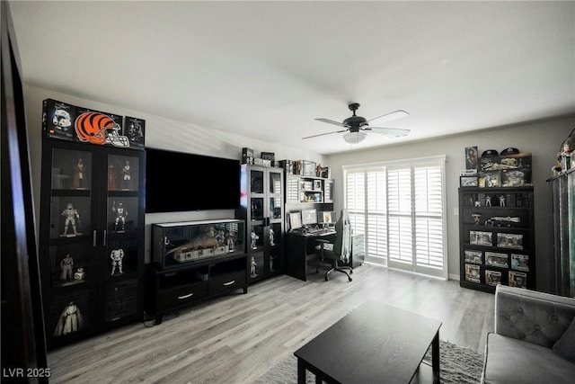 living room with hardwood / wood-style flooring and ceiling fan