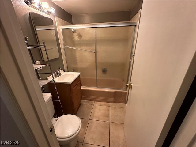 full bathroom with tile patterned flooring, vanity, shower / bath combination with glass door, and toilet