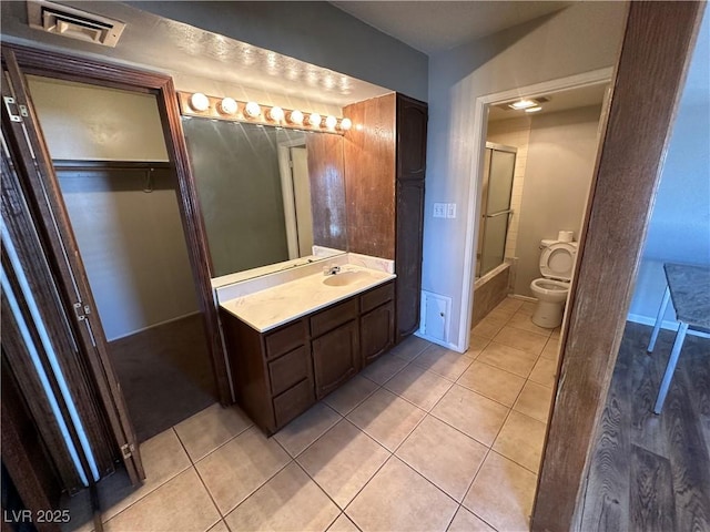 bathroom with vanity, tile patterned floors, and toilet