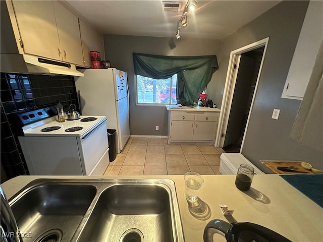 kitchen with white cabinetry, light tile patterned floors, white appliances, and decorative backsplash