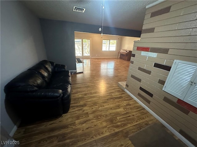 living room with hardwood / wood-style floors and a textured ceiling