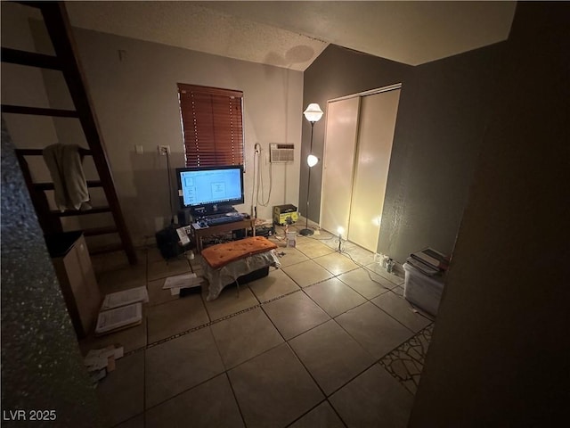 unfurnished living room with light tile patterned flooring, vaulted ceiling, and a wall mounted AC