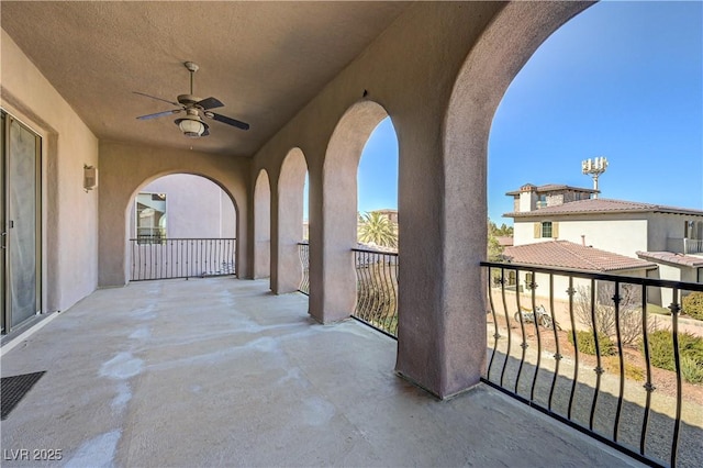 view of patio / terrace featuring ceiling fan and a balcony