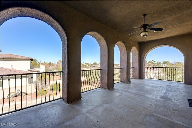 view of patio / terrace with a balcony and ceiling fan