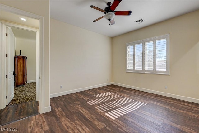 spare room featuring ceiling fan and dark hardwood / wood-style flooring