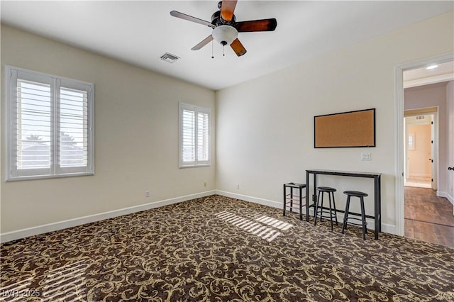 carpeted empty room featuring ceiling fan