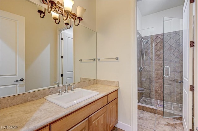 bathroom featuring a shower with door and vanity