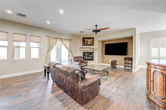 living room with hardwood / wood-style flooring and ceiling fan