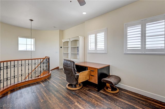 home office with ceiling fan, a healthy amount of sunlight, and dark hardwood / wood-style flooring