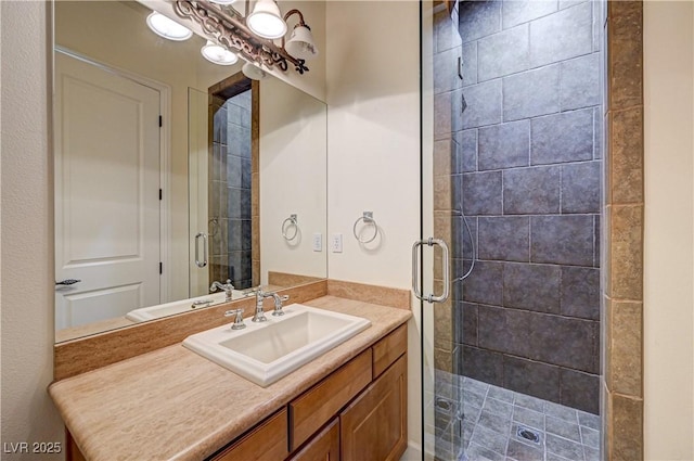 bathroom with vanity and a shower with door