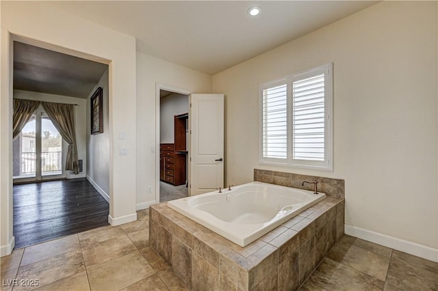 bathroom with tiled tub