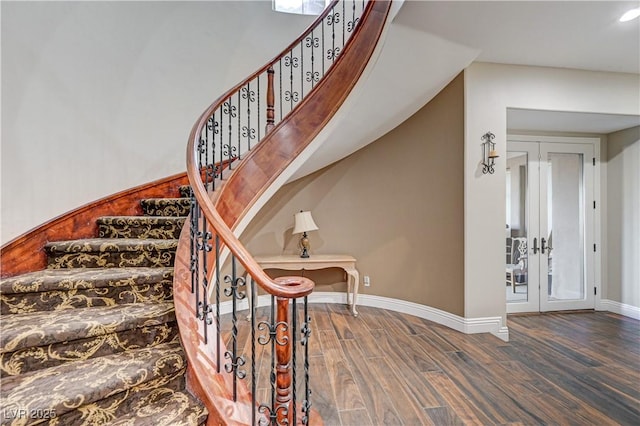 staircase with french doors and wood-type flooring