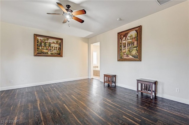 spare room featuring dark hardwood / wood-style floors and ceiling fan