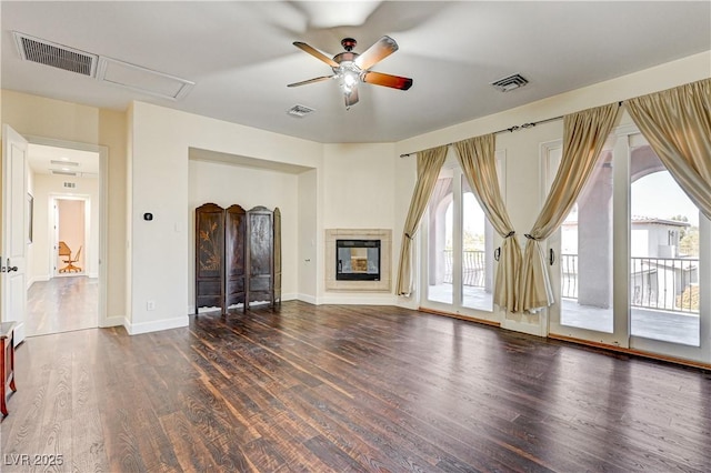 unfurnished living room with ceiling fan and dark hardwood / wood-style flooring