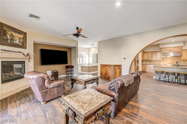 living room with ceiling fan and hardwood / wood-style floors