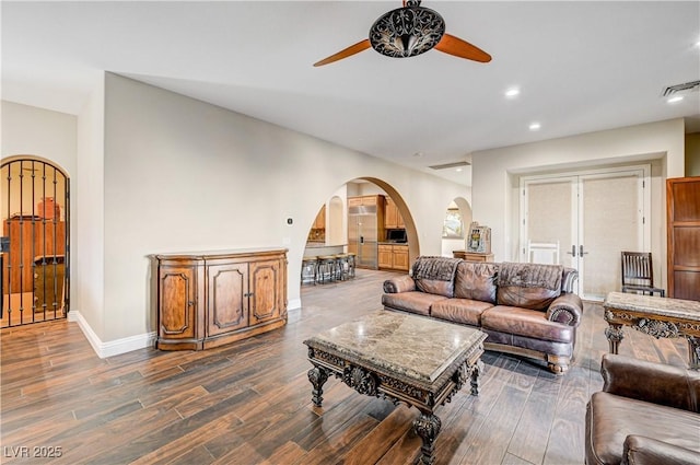 living room featuring ceiling fan and hardwood / wood-style floors