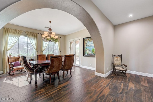 dining area with an inviting chandelier and dark wood-type flooring