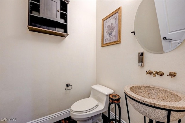 bathroom featuring sink and toilet