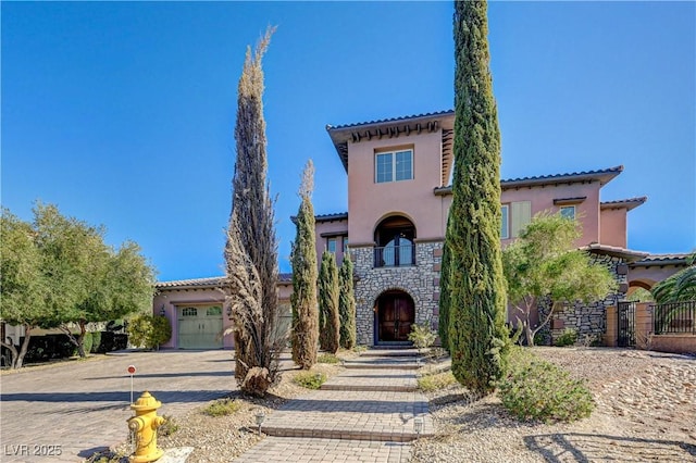 mediterranean / spanish house featuring a garage