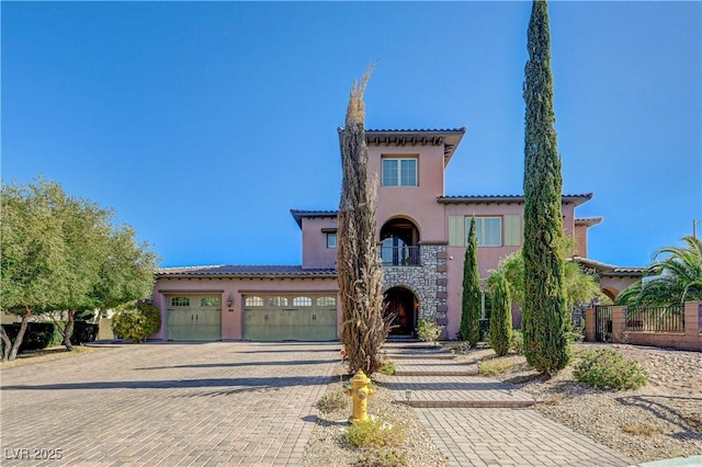 mediterranean / spanish home with a garage