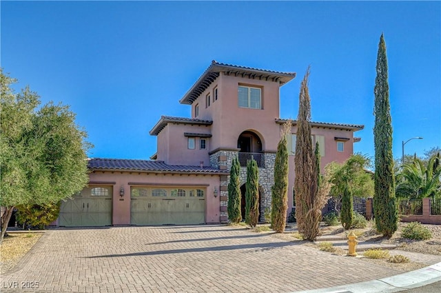 mediterranean / spanish house with a garage