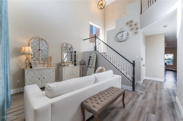 living room featuring light hardwood / wood-style floors and a high ceiling