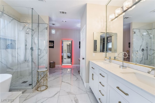 bathroom with vanity and a shower with door