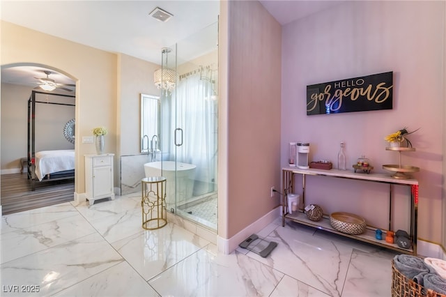 bathroom featuring ceiling fan and a shower with door