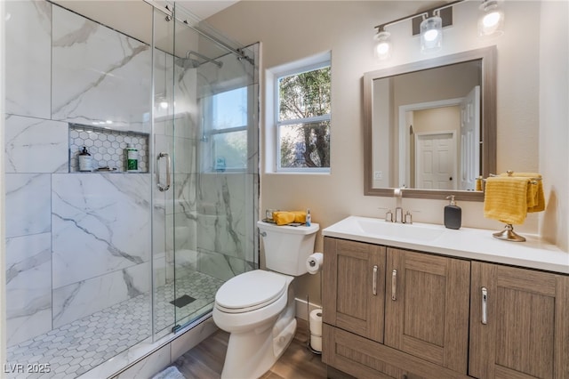 bathroom featuring vanity, toilet, and walk in shower