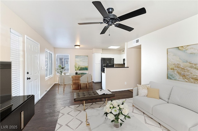 living room featuring ceiling fan and light wood-type flooring